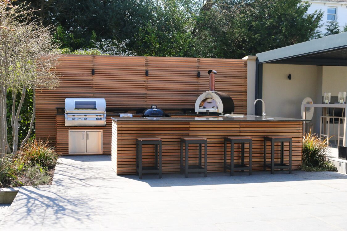 cedar cladded outdoor kitchen with fire magic bbq